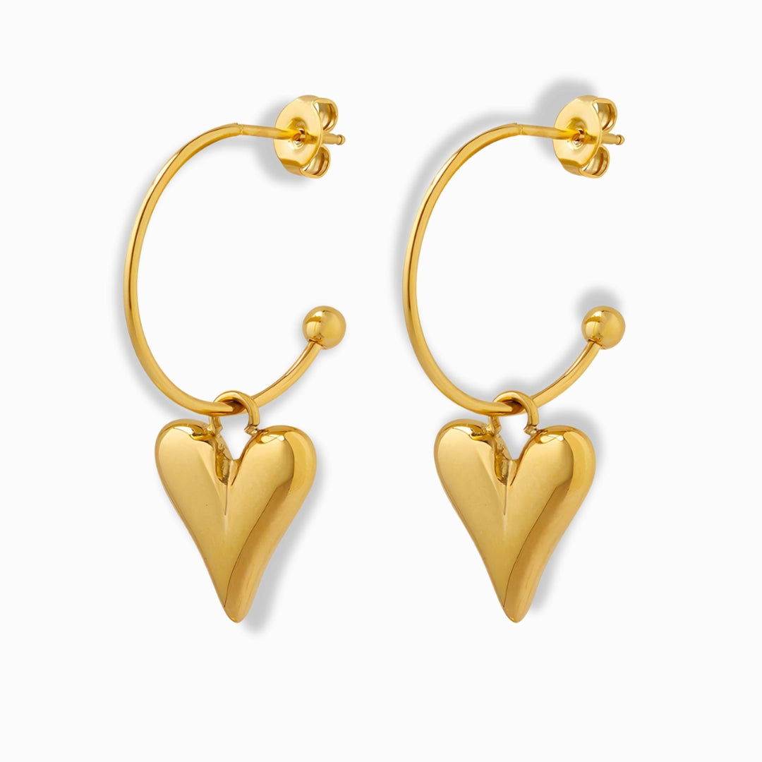 Glozya 18K Gold Plated Swinging Heart Stud Earrings featuring a playful heart design with a secure stud closure. Made from stainless steel with triple-layer 18K gold plating, they are hypoallergenic, waterproof, and tarnish-free.