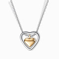 Stainless steel two-tone heart pendant necklace in silver and gold plating.